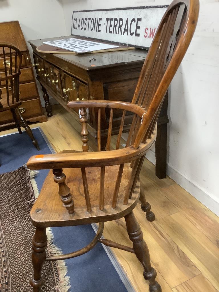 A single early 19th century yew and elm elbow chair